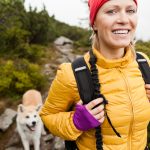 woman hiking with dog