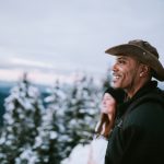 Hikers Look At View of Snow Covered Pacific Northwest