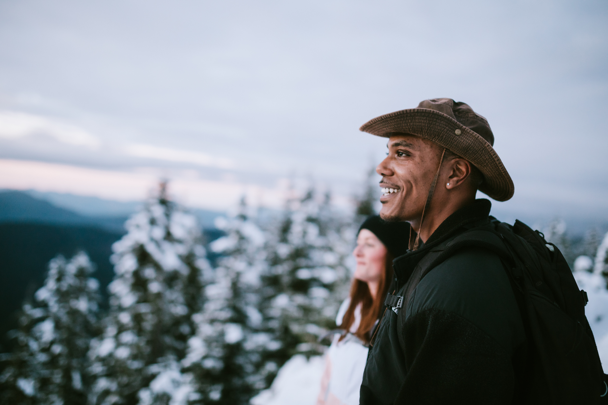 Hikers Look At View of Snow Covered Pacific Northwest